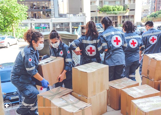 Røde Kors-frivillige bærer esker