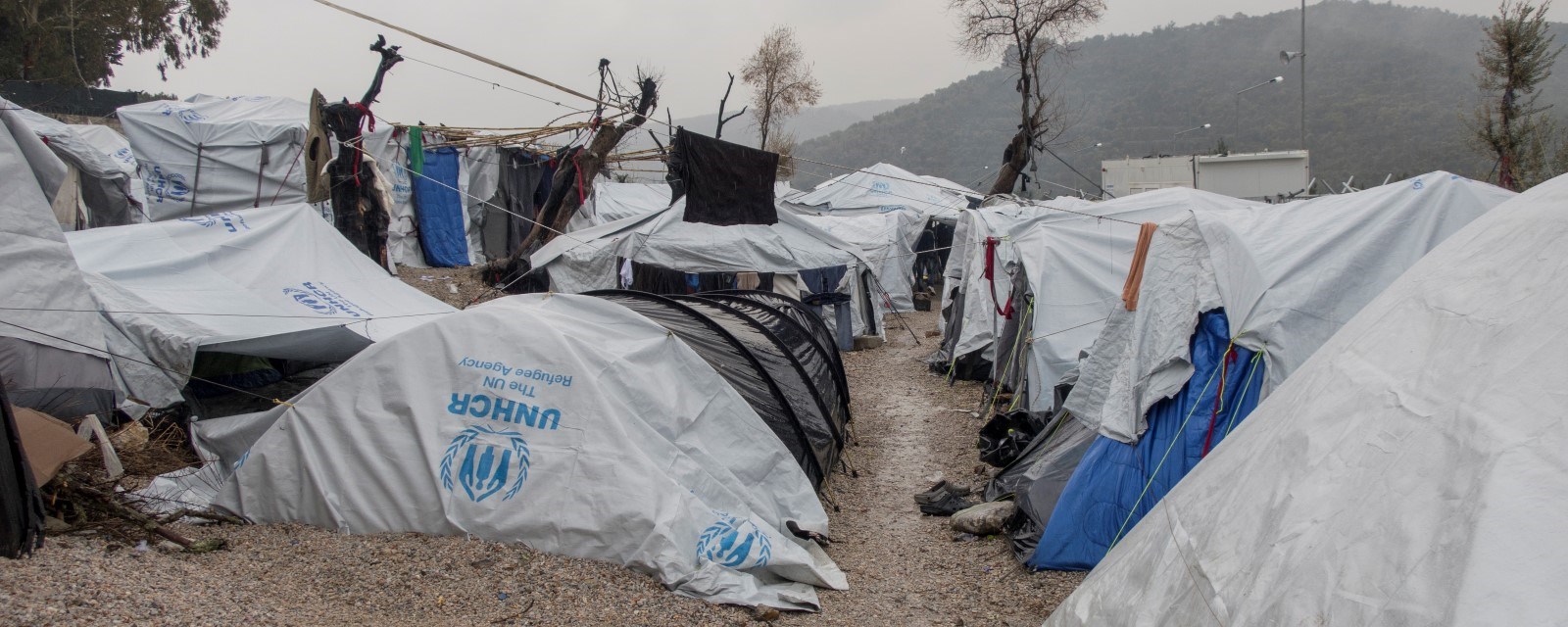 Provisoriske telt satt sammen av presenninger står tett i tett i flyktningleiren. Det regner 
