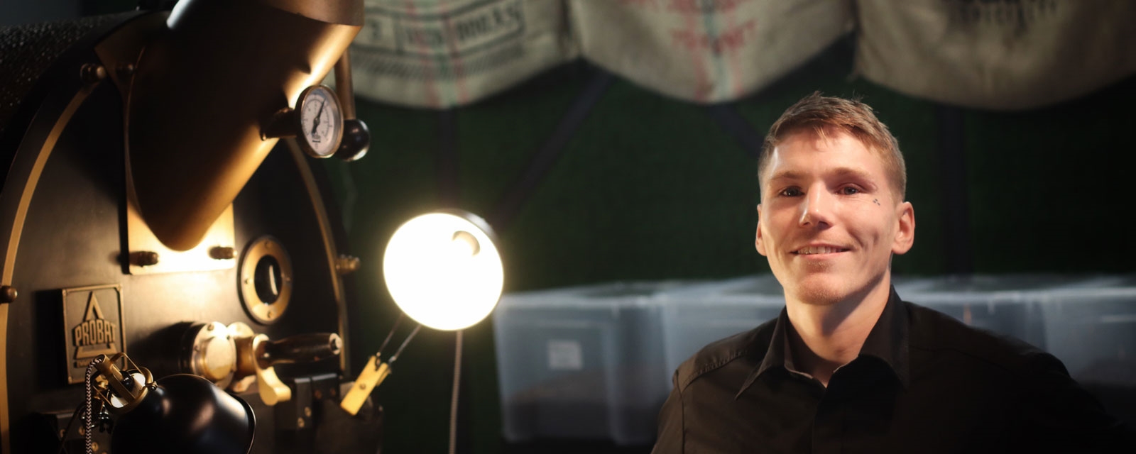 Mann foran kaffebrenner