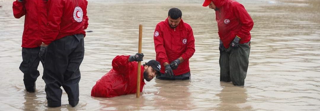 Fire frivillige i Libya Røde Halvmåne jobber med vann over knærne