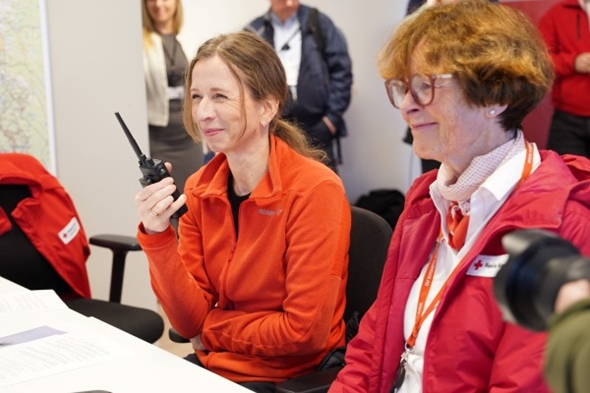 justisministeren holder en walkietalkie og erklærer Røde Kors sin påskesentral for åpnet.