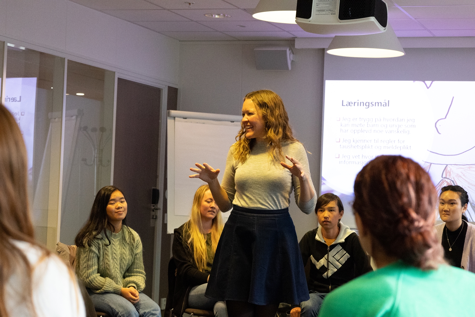 Kvinne holder snakker til forsamling