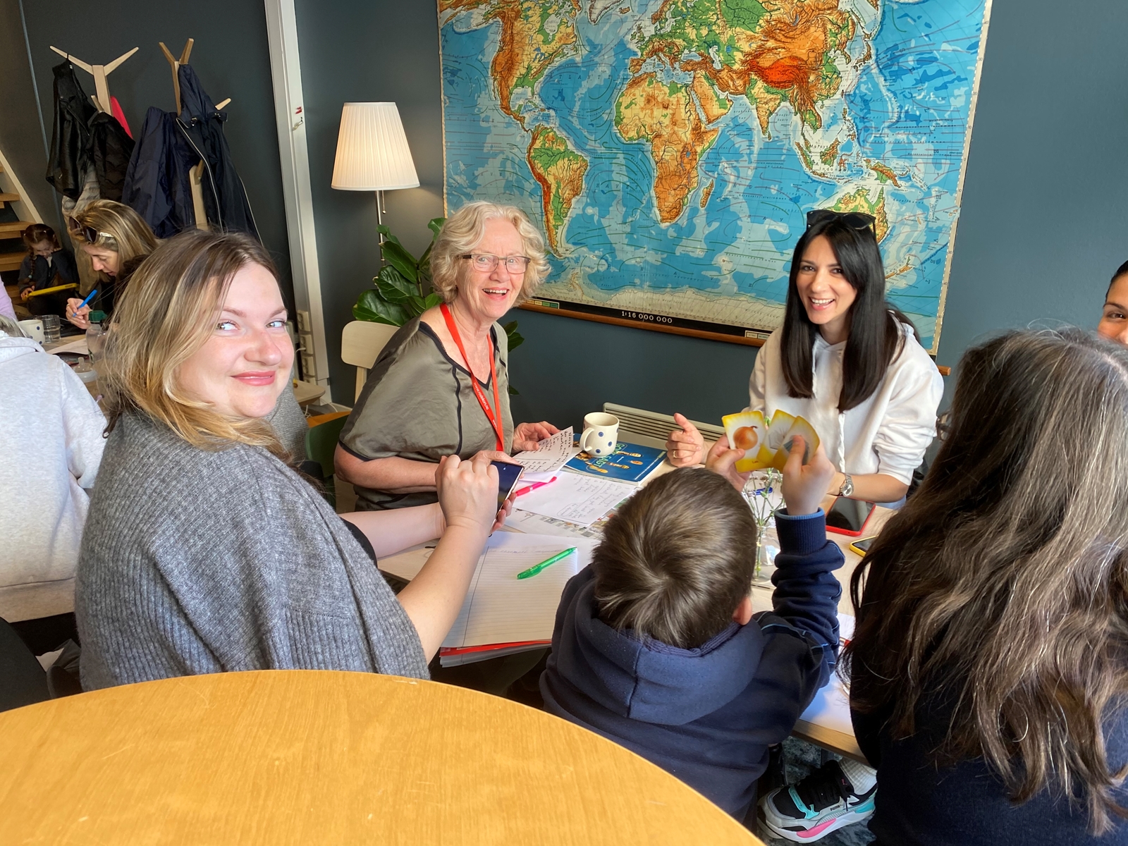 Flyktninger fra ukraina sammen med frivillig norsktrener på Røde Kors-huset under norsktrening i regi av frivillige i Bergen Røde Kors.