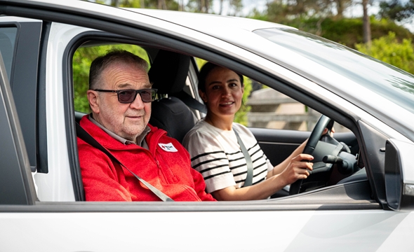 en dame bak rattet og kjørvert som passasjer