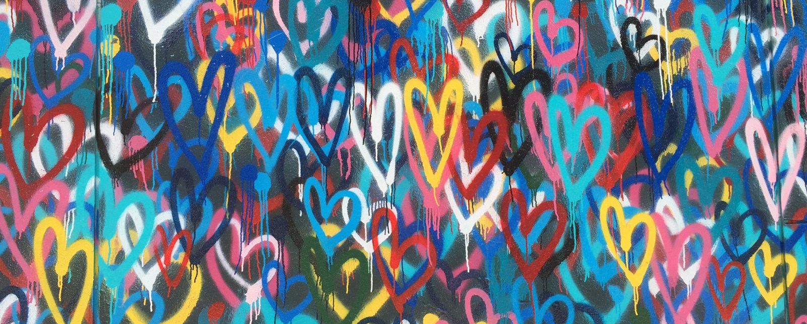 Illustrasjonsbilde av mange hjerter i mange farger på en vegg