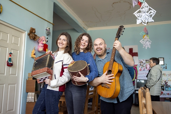 Tre flotte ungdommar spelar på instrument