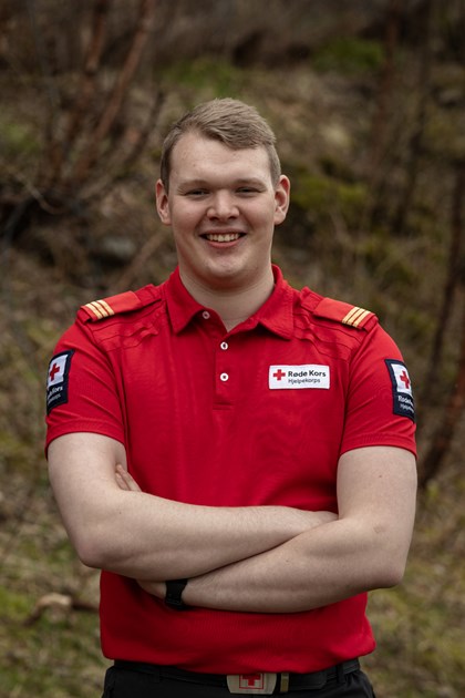 Ung mann i rød t-skjorte med gule striper på skuldrene