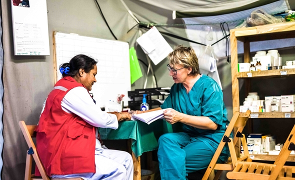 The Finnish midwife Jaana Laine is taking the temperature of a new born baby at the maternity ward, May 2018 (Photo: Finnish Red Cross). 