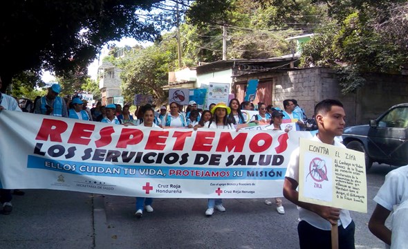 September, 2018. A health campaign raised awareness around health care for vector-borne diseases in Comoyaguela, Honduras. The banner is encouraging people to respect health care workers, due to high levels of violence in this community (Photo: San Fransisco Health Centre). 
