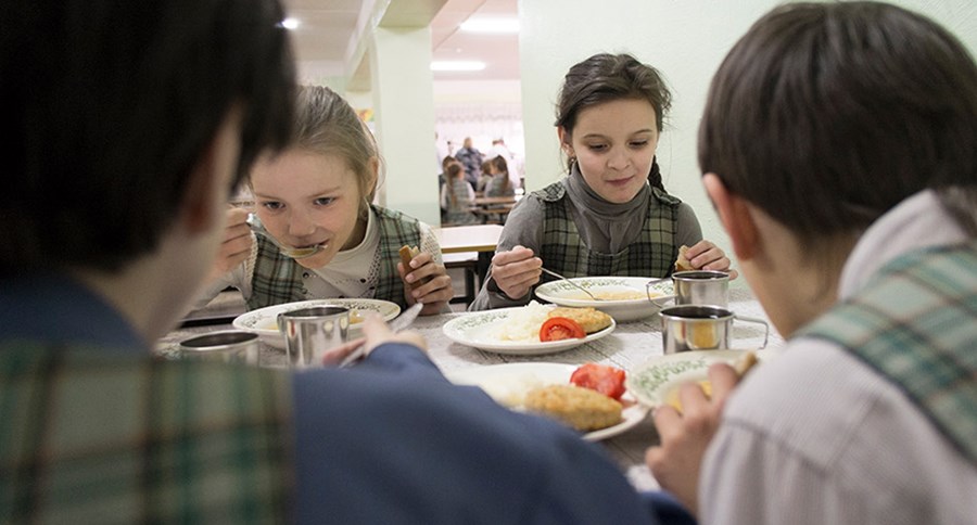 Young children eating supper, indoors, russia