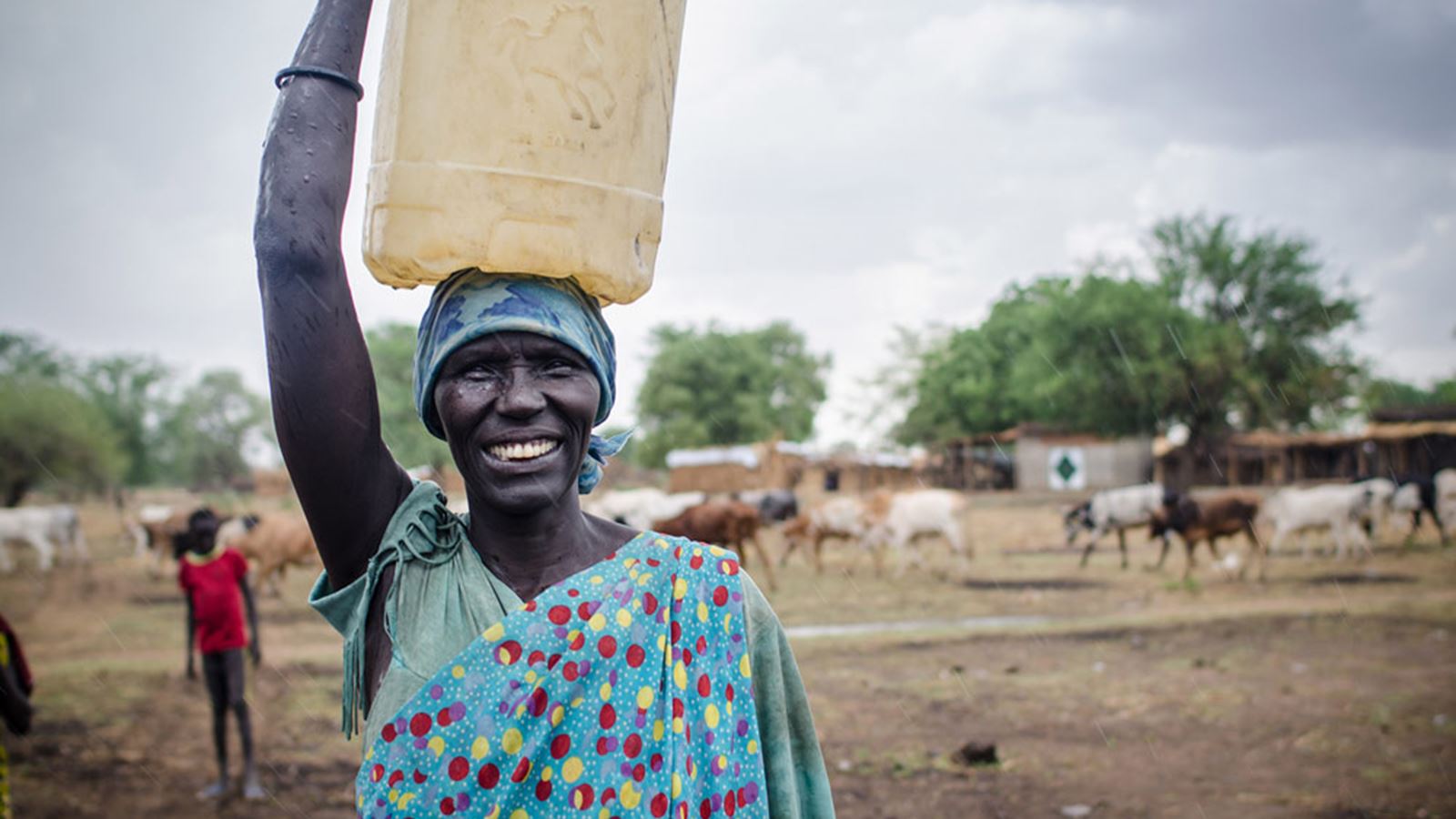 Woman carrying a water can on Her head