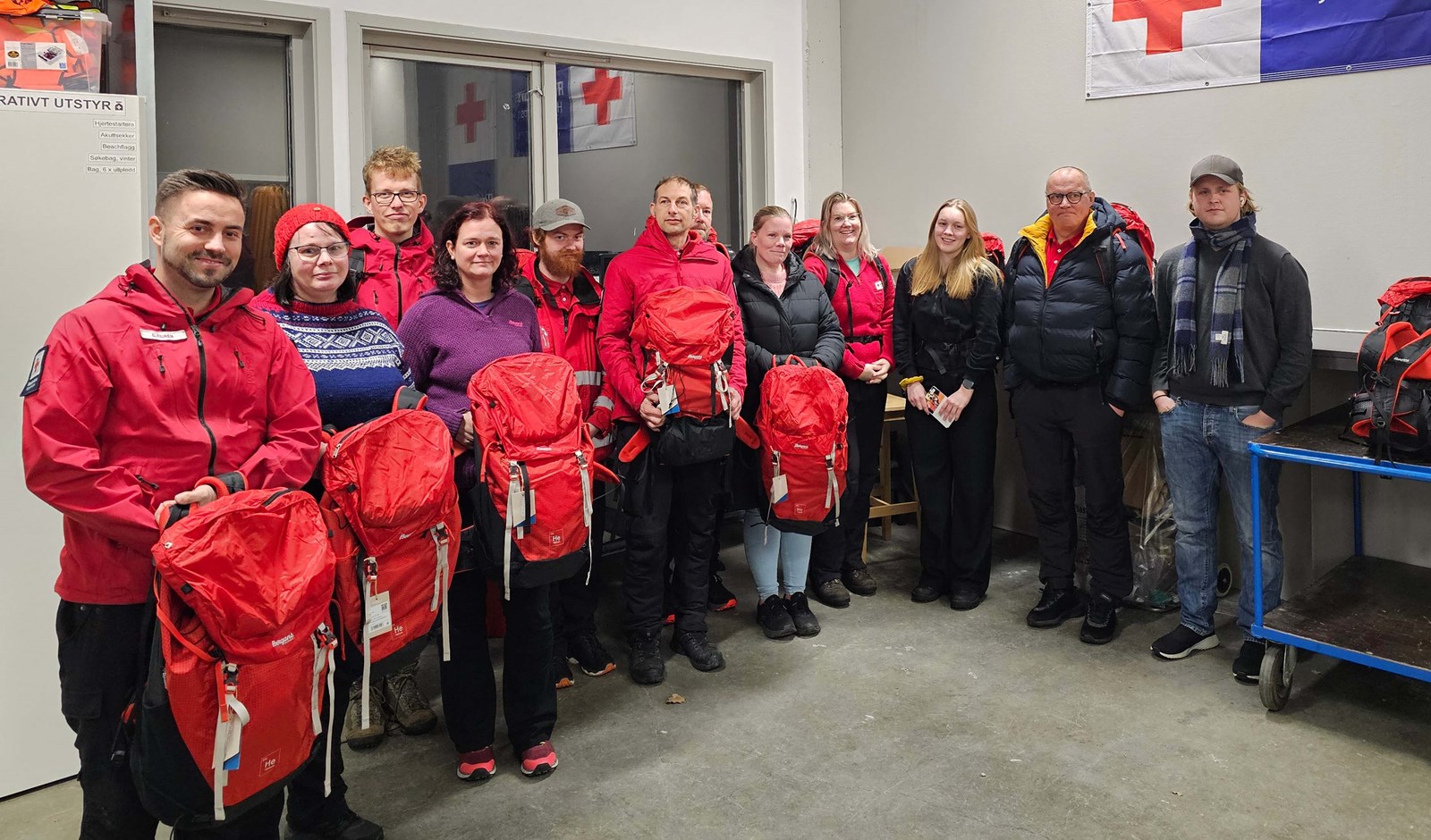 12 medlemmer i Arendal Røde Kors Hjelpekorps viser frem de nye beredskapssekkene sine. 