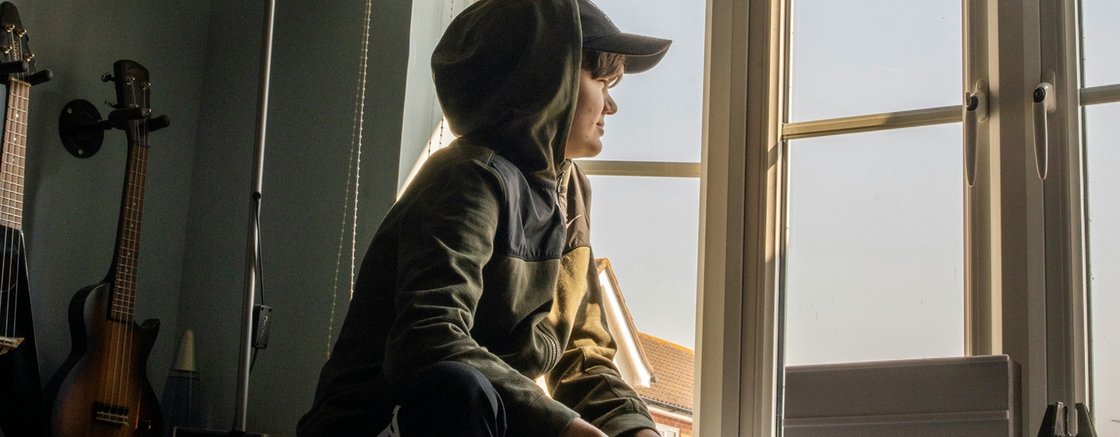 Barn sitter og ser ut vinduet